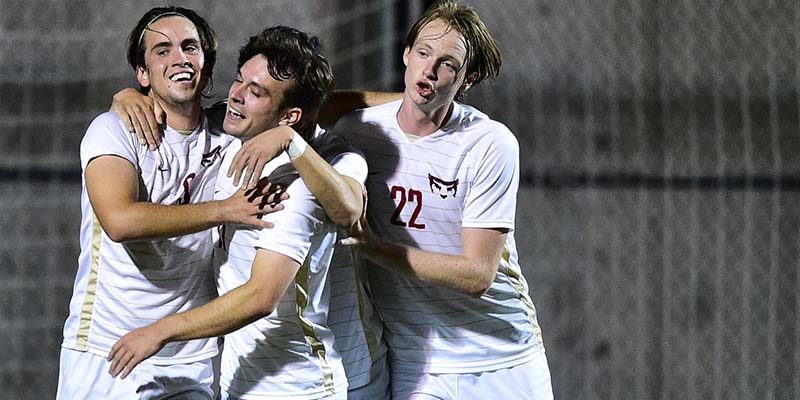 Jett Starr, left, celebrates with teammates after scoring a goal.