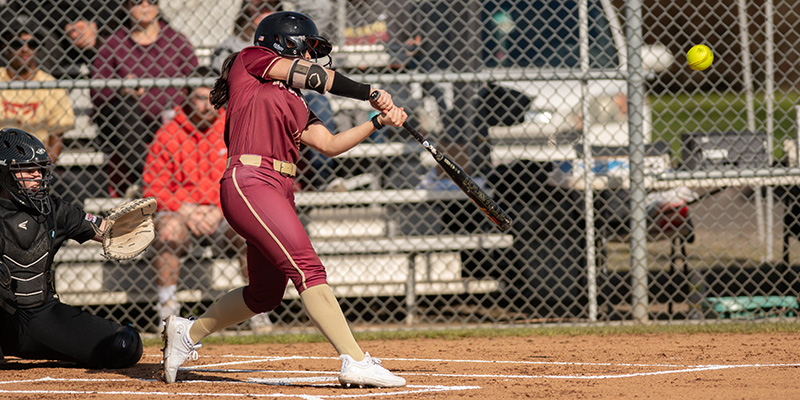 Emma Elliott takes a swing for the Willamette softball team.