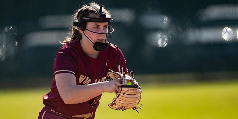 Kenna Davis holds the ball in her glove before starting a pitch.