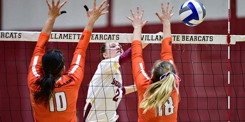 Olivia Cadien sends an attack past a two-player block.