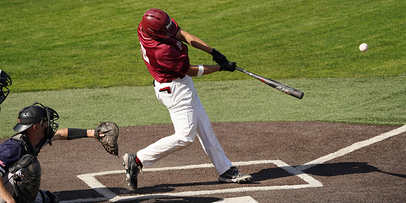 Trey Topping hits the ball for the Bearcats.