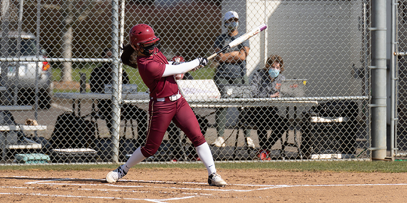 Mia Lund completes a strong swing with the bat.