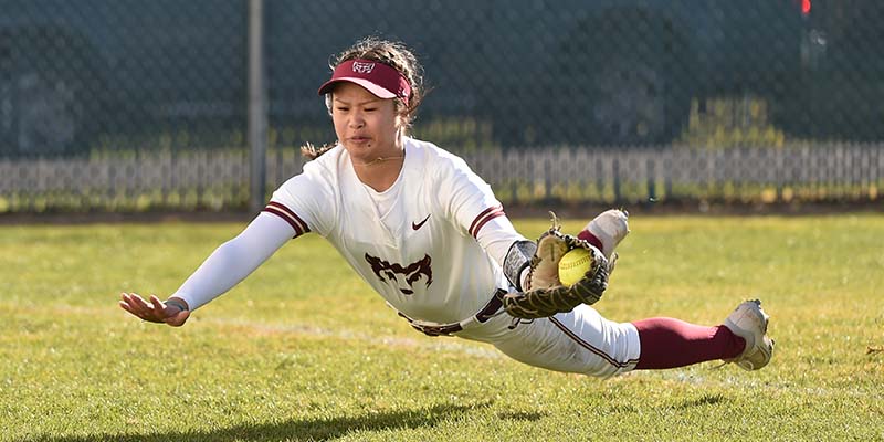 Mia Lund makes a diving catch in the outfield for the Bearcats