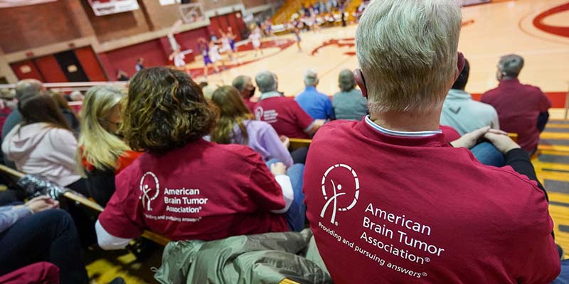 Fans wear American Brain Tumor Association t-shirts while watching the Bearcats compete during the Play for ABTA night at Cone Field House.