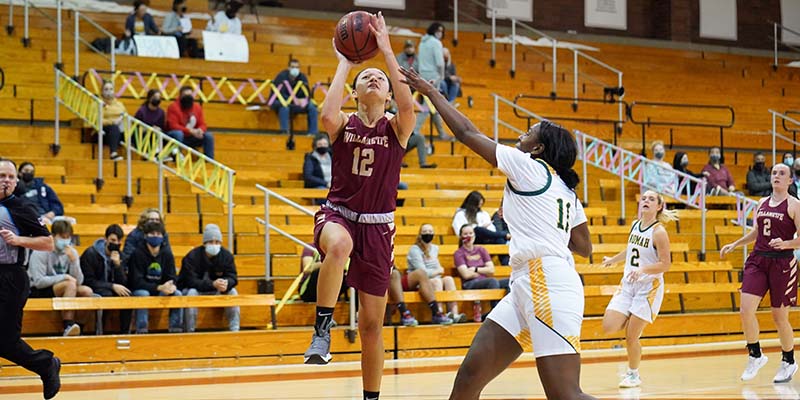 Carolyn Ho shoots a driving layup for Willamette.