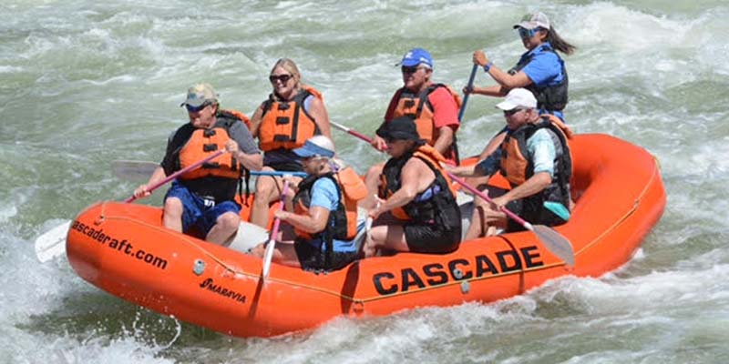 Claire Bonnet, top right, leads six clients on a whitewater rafting trip.