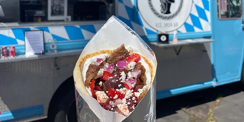 Gyro in front of The Mighty Greek food truck