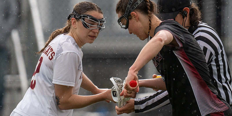 Brooklyn Pearl, left, and a Whitworth player, right, prepare for a draw during the 2024 NWC Semifnals.