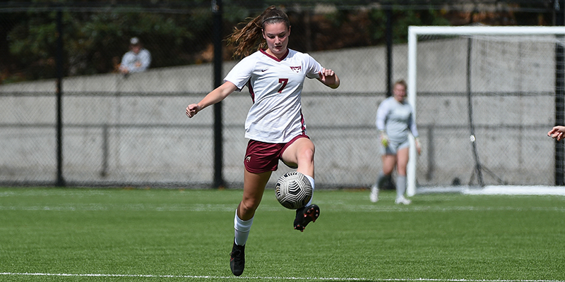 Willamette women's soccer player Ella Abraham collects the ball and heads towards the goal
