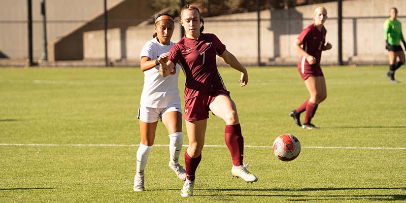 Samantha Lute shields the ball from a defender.