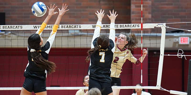 Olivia Cadien hits the ball past a blocker.