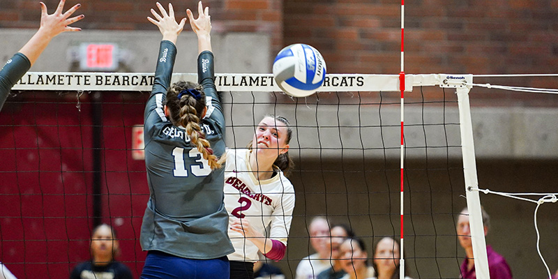 Olivia Cadien hits an attack off a blocker's arm.