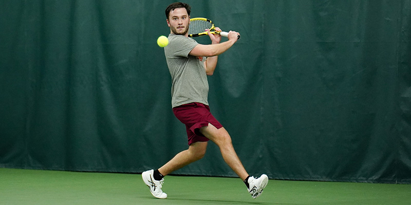Andre Lief returns with a backhand for the Willamette men's tennis team.