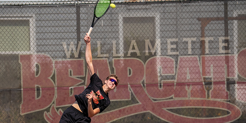 Andrew Kabacy strikes the ball on a serve.