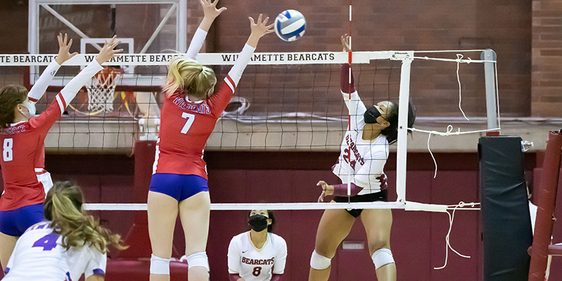 Dani Queja sends an attack off the hand of a defender at the net.