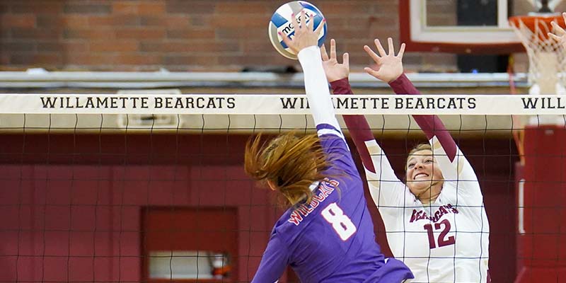 Lexi Martin matches up with an opposing attacker to set up a block.